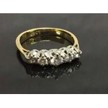 An 18ct gold five stone diamond ring, size G.