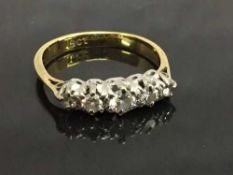 An 18ct gold five stone diamond ring, size G.