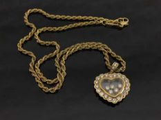 An 18ct gold Chopard Happy Curves diamond pendant on chain, 18.4g, with retail box and documents.