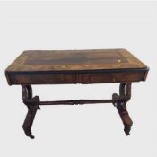 A Victorian inlaid rosewood side table fitted with three drawers, on harp and string supports,
