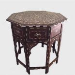 A late nineteenth century Moorish folding occasional table profusely inlaid with ivory and ebony.