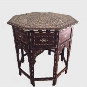 A late nineteenth century Moorish folding occasional table profusely inlaid with ivory and ebony.