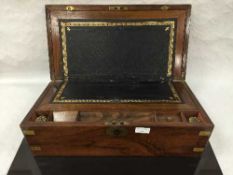 A nineteenth century rosewood and brass bound writing slope with tooled leather insert.