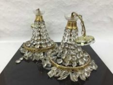 A pair of early twentieth century cut crystal light fittings with droplets.
