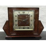 An Art Deco oak cased 8 day mantel clock, the square silvered dial with arabic numerals,