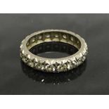 An early twentieth century white gold diamond eternity ring, size N.
