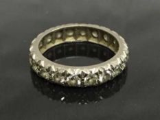 An early twentieth century white gold diamond eternity ring, size N.