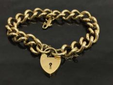A 9ct gold bracelet upon which hangs a 9ct gold crocodile charm, with padlock, 60.6g.