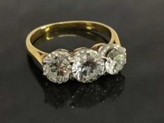 An 18ct gold three stone diamond ring, approximately 2.02ct, clarity Si-1, colour H-I, size M.