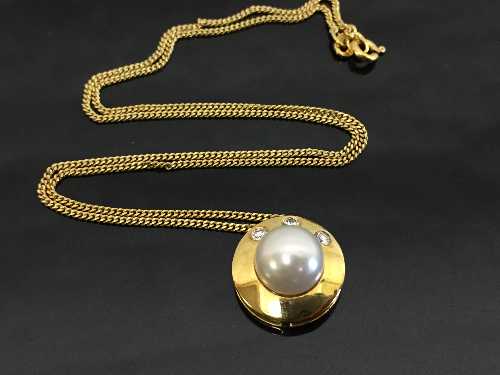 An 18ct gold pearl and diamond pendant on fine 18ct chain.
