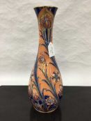 A James Macintyre gilded vase, decorated with red and blue flowers on peach ground, height 41 cm.