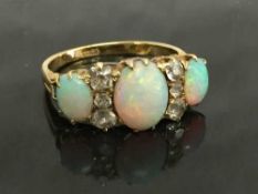 An 18ct gold opal and diamond ring, size O.