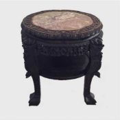 A nineteenth century Chinese carved hardwood occasional table with rouge marble top and under
