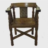 A carved oak armchair by Robert 'Mouseman' Thompson of Kilburn, width 62 cm.