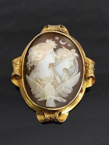 A fine late Victorian yellow gold cameo brooch depicting angels by a dove.