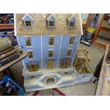 A large four storey Georgian style dolls house and two boxes of assorted dolls house furniture and