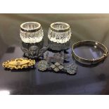 A collection of silver brooches, two silver bangle,