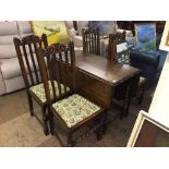 An oak barley twist leg dining table and four high backed chairs