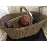 A wicker log basket containing tribal carvings, mangle,