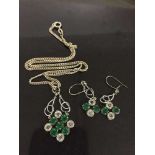 A silver earring and pendant set