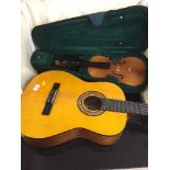 Chinese violin in soft carry case together with a classical style acoustic guitar