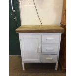 A pine topped painted cabinet fitted three drawers