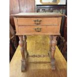 An early 20th century oak work table fitted two drawers