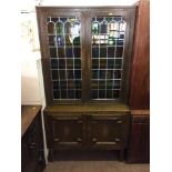 An oak leaded door bookcase