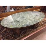 An oval marble topped coffee table on pine base