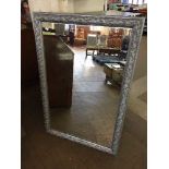 A silvered framed mirror