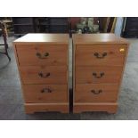 A pair of pine effect bedside chests