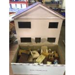 A wooden doll's house together with a large quantity of furniture including fireplace, armchairs,