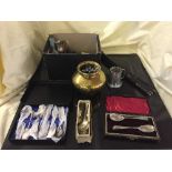 A box of plated tankards, cased serving spoons, crested spoons, brass vase,