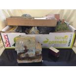 A box of model railway accessories including buildings, plastic carriages,