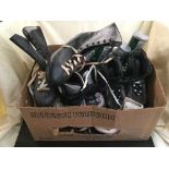 A box of vintage ice skates, wooden croquet set, badminton rackets,