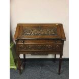 A carved oak lady's bureau fitted a drawer