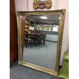 A gilt framed bevelled overmantle mirror.