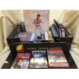 A box of Elvis memorabilia and DVDs