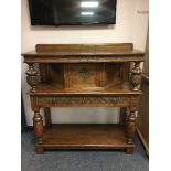 A carved oak buffet sideboard