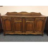 A French oak dresser fitted with two drawers above cupboard doors.