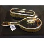 Two silver and tortoiseshell dresing table brushes