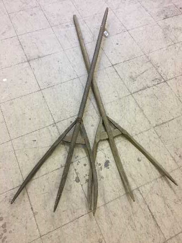 Two rustic hay forks