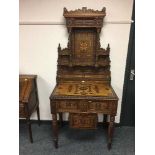 An early 20th century parquetry inlaid teak hallstand.