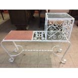 A wrought iron glass topped coffee table