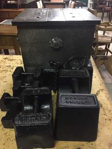 A chrome coal box with eight assorted weights