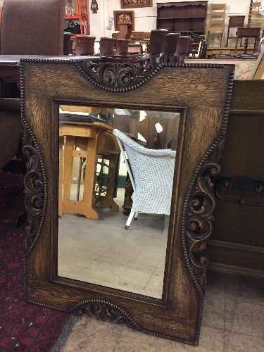 An Edwardian carved oak framed mirror