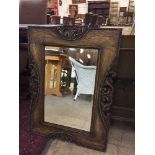 An Edwardian carved oak framed mirror