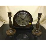 An oak Westminster chime mantel clock and a pair of candlesticks