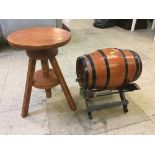 An adjustable stool and a metal bound barrel on stand
