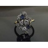 A sapphire and diamond cluster ring, the stones in raised claw settings,